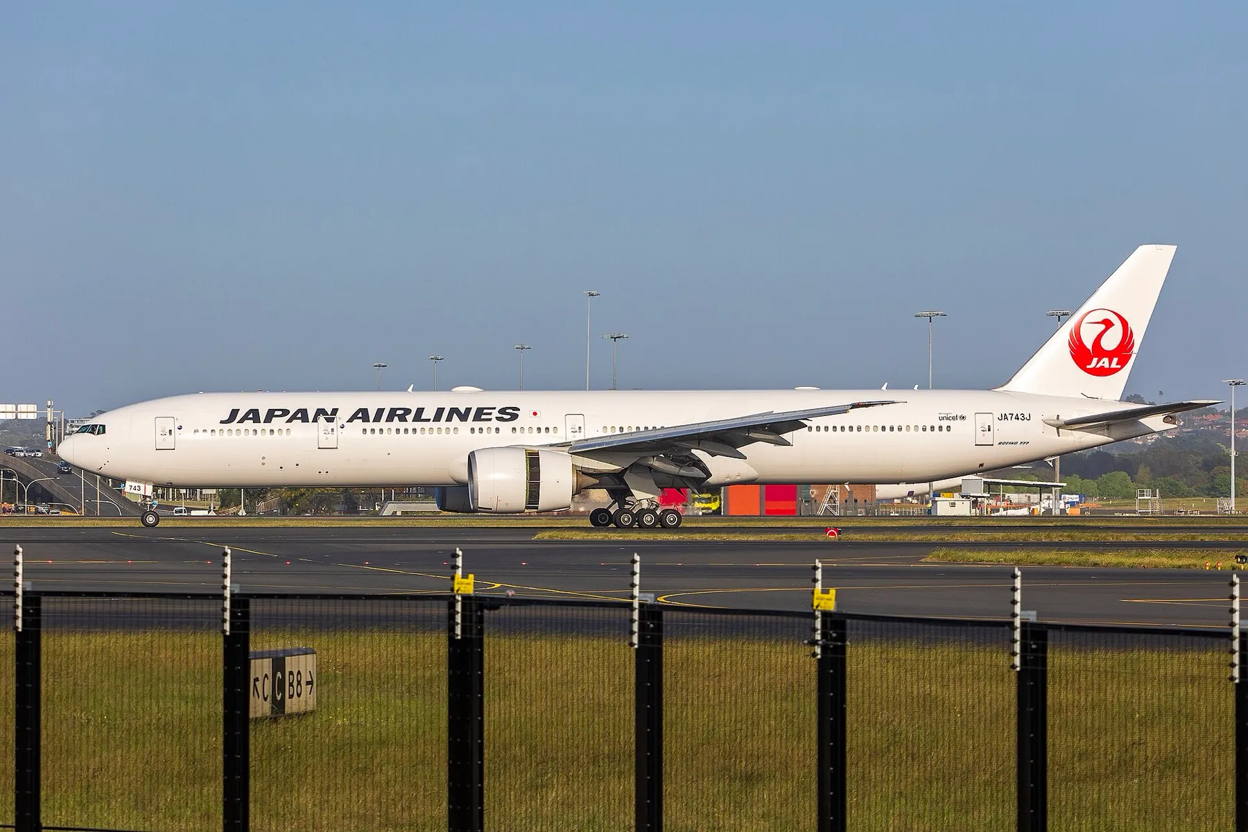 A Japan Airlines Boeing 777-300ER on the taxiway at Sydney Airport in morning light